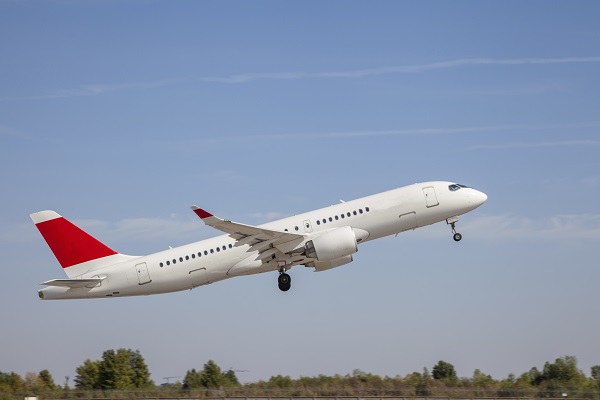 White plane flies in the sky. Takeoff and landing. Arrival and departure. Place for your text. Passenger plane isolated on blue background. Passenger airplane. Travel by air transport. Flying.
